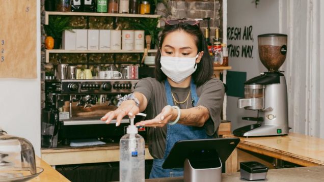 retail-staff-sanitizing-her-hands
